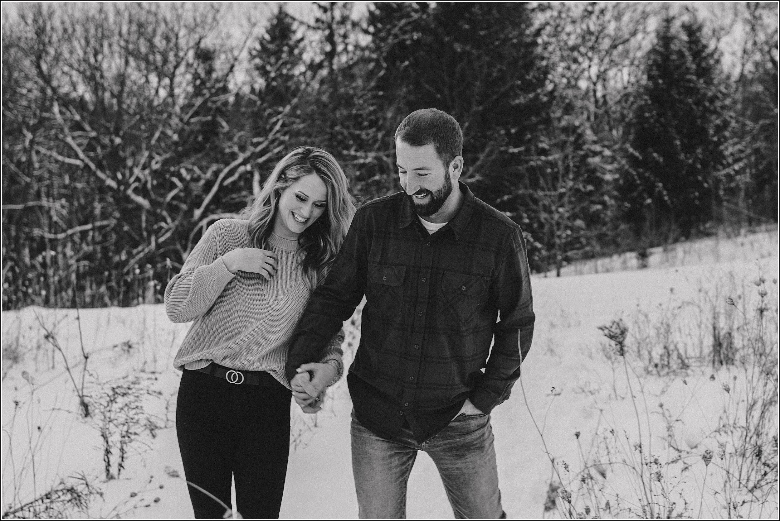 la crosse wi winter engagement session black and white engagement picture playing in the snow