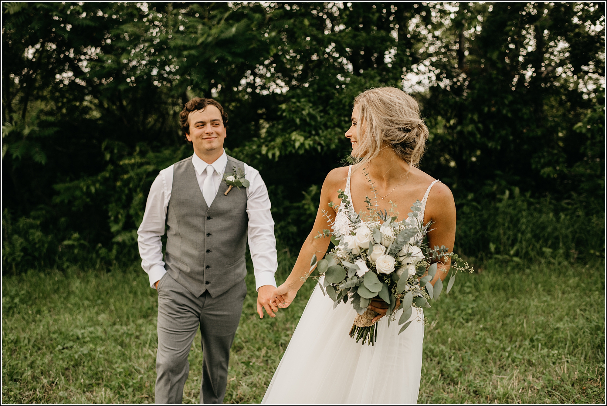La Crosse, WI wedding photographer bride and groom walking outside