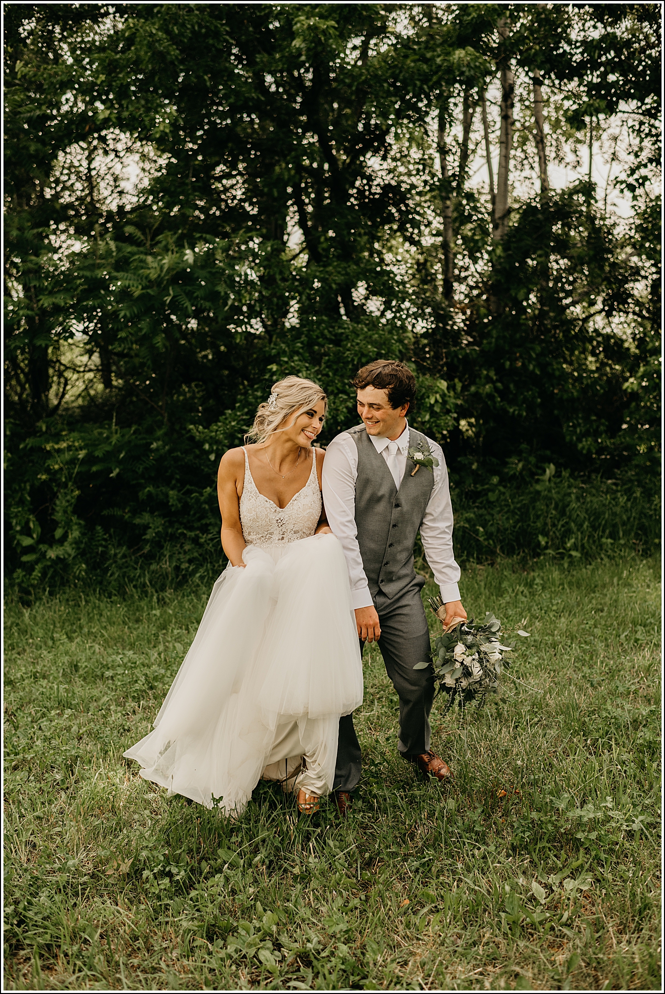 La Crosse Wedding Photographer bride and groom walking flirting bumping