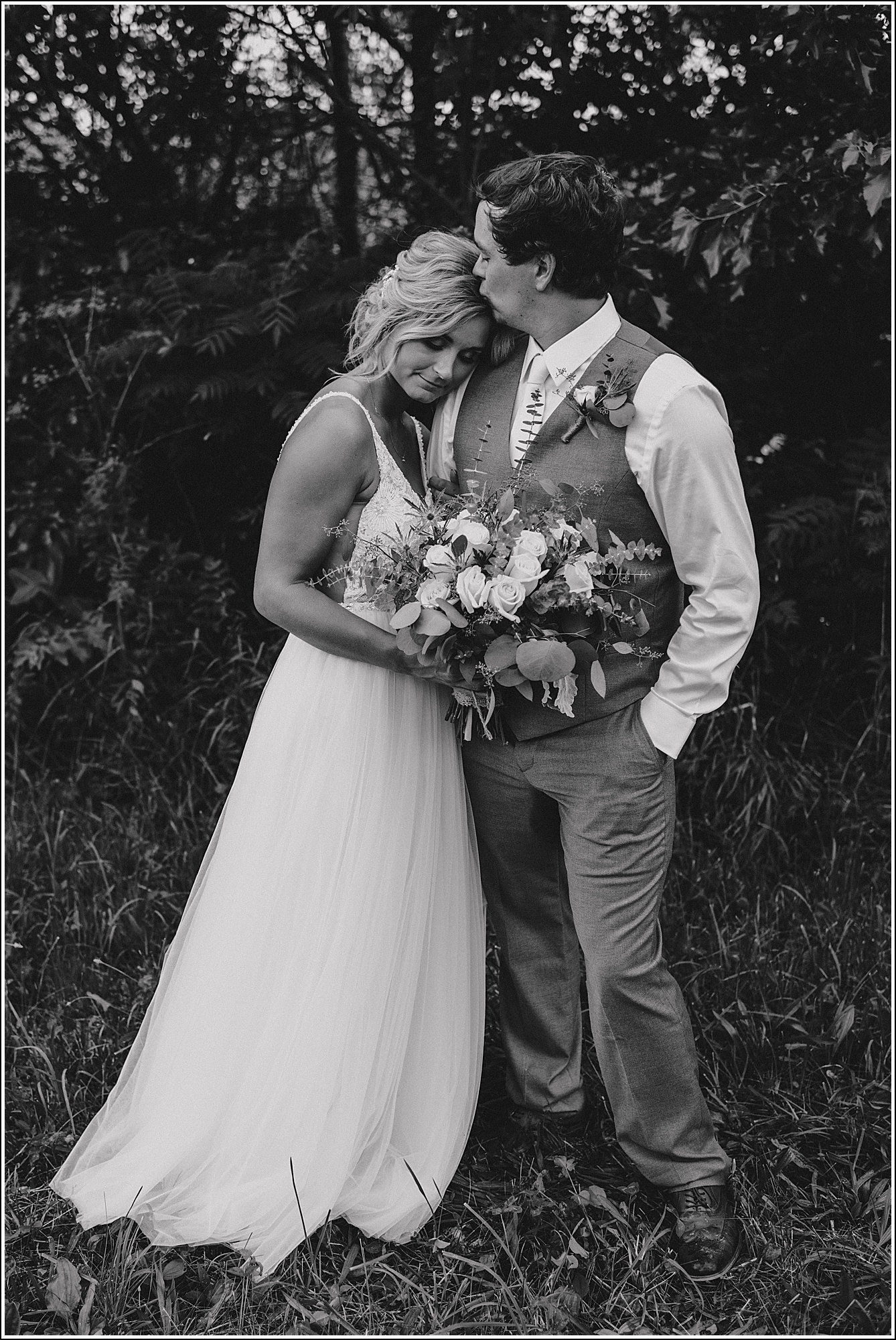 La Crosse Wedding photographer black and white groom kissing bride